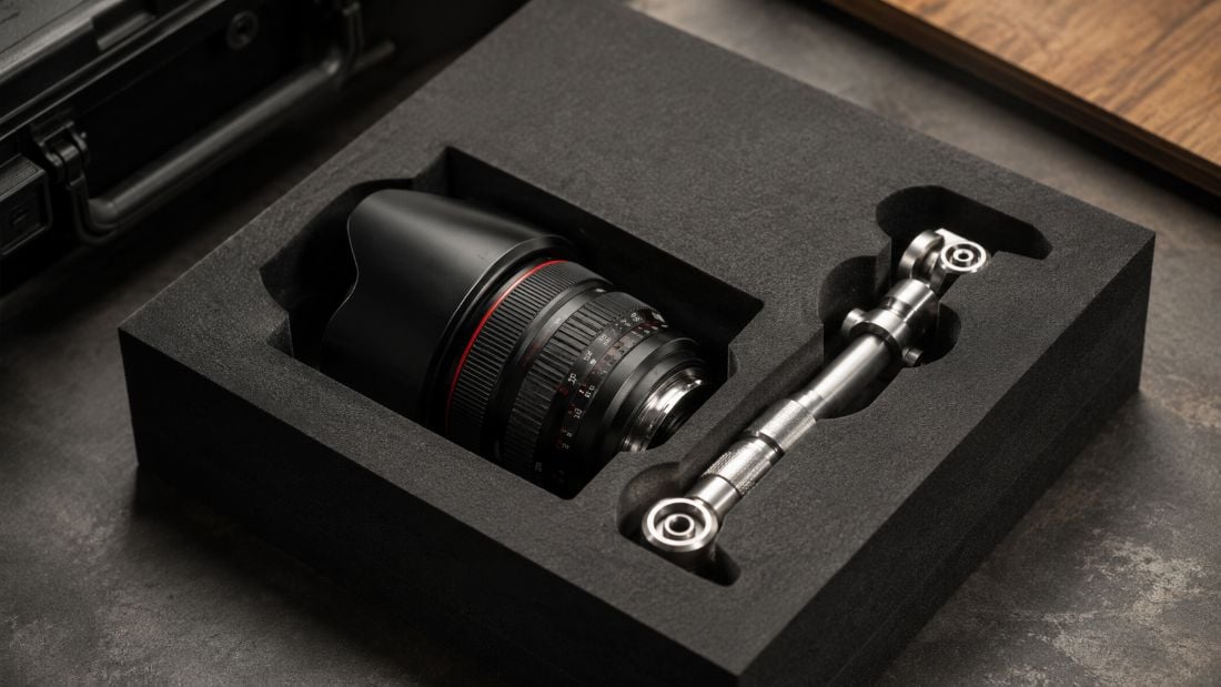 Custom CNC-routed foam insert with milled cavities holding a camera lens