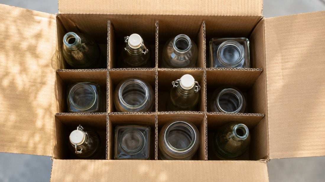 Kraft corrugated cardboard partitions separating glass bottles in a shipping box